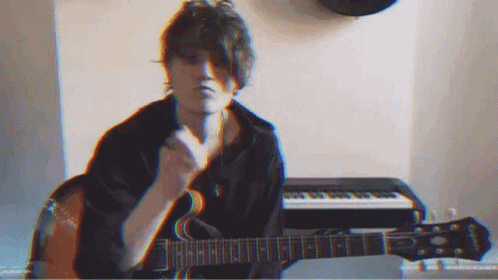 Man Playing Guitar and Singing