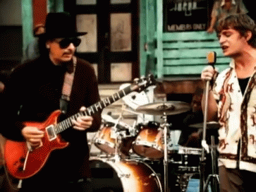 Man Playing Guitar Beside Singing Man