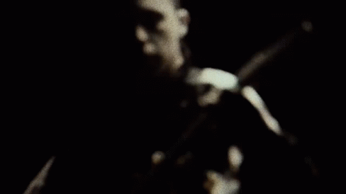 Man Playing Guitar in Darkness