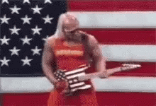 Man Playing Guitar In Front Of American Flag GIF