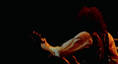 Man Playing Guitar in Front of Crowd