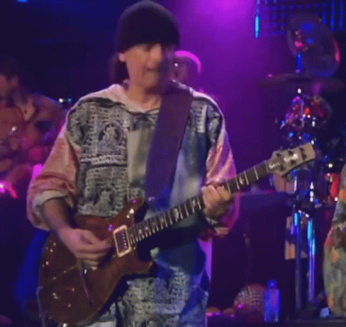 Man Playing Guitar With Band Saying Santana GIF