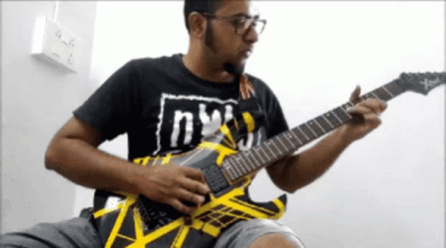 Man Playing Guitar With Shirt Saying NY
