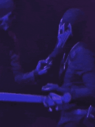 Man Playing Guitar with Skull Face