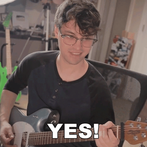 Man Playing Guitar With Yes Written on Face