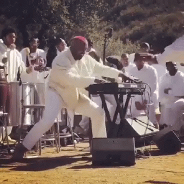 Man Playing Keyboard in Front of Crowd