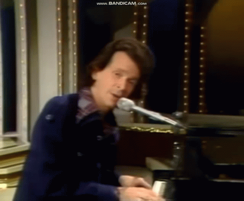 Man Playing Piano at Microphone