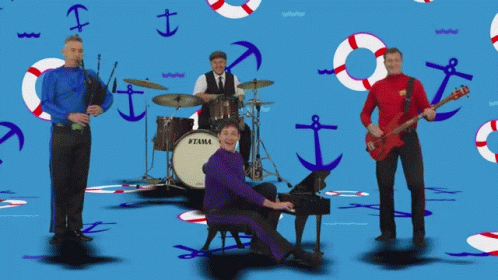 Man Playing Piano in Front of Tama Drum Set