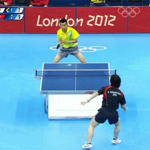 Man Playing Ping Pong in Front of London 2012 Sign