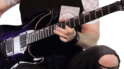 Man Playing Purple Electric Guitar