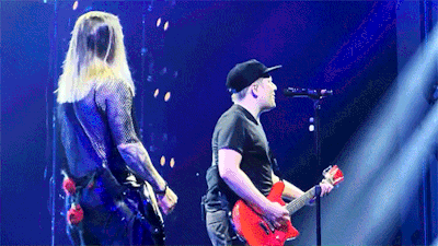 Man Playing Red Guitar On Stage With Singer GIF