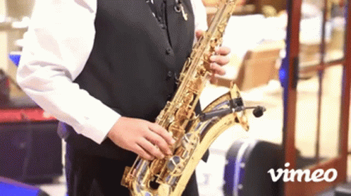 Man Playing Saxophone in Front of Vimeo Sign