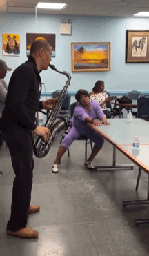 Man Playing Saxophone While Woman Sits on Table