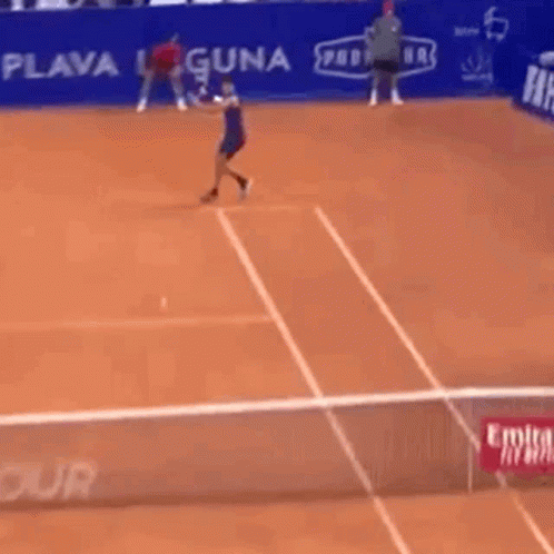 Man Playing Tennis in Front of Hotel Banner