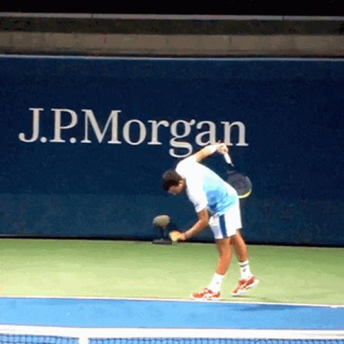Man Playing Tennis In Front Of J.P. Morgan Ad GIF