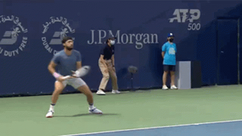 Man Playing Tennis In Front Of J.P. Morgan Banner GIF