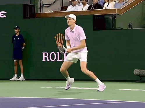 Man Playing Tennis In Front Of Rolex Wall GIF