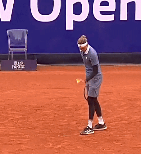 Man Playing Tennis in Front of Sign Saying Open