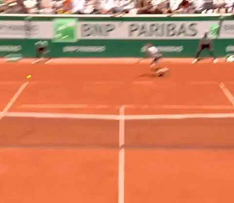 Man Playing Tennis With BNP Paribas Banner