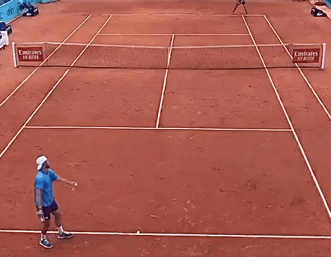 Man Playing Tennis With Mutua Madrilena Banner