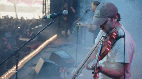 Man Playing Violin Singing into Microphone with Georgia Hat
