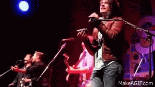 Man Playing Violin Singing on Stage