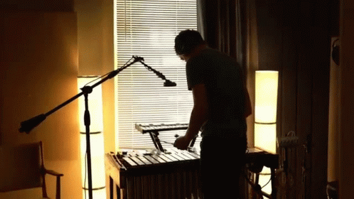 Man Playing Xylophone In Dark Room GIF