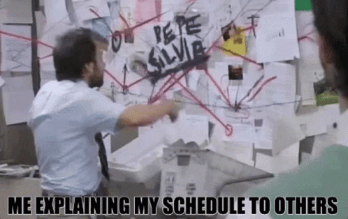 Man Pointing at Bulletin Board Saying Me Explaining My Schedule