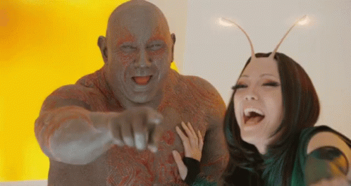 Man Pointing at Camera Posing With Woman
