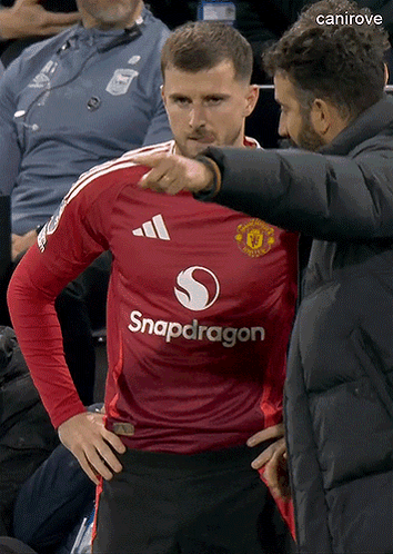 Man Pointing at Man in Red Snapdragon Jersey