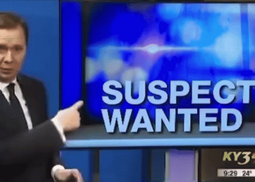Man Pointing at TV Screen Saying Suspect Wanted