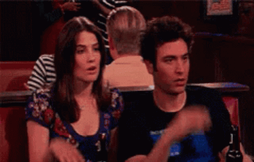 Man Pointing At Woman Sitting Next To Her GIF