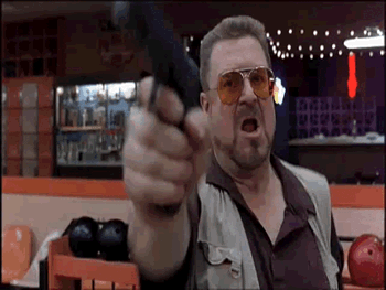 Man Pointing Gun at Camera in Bowling Alley