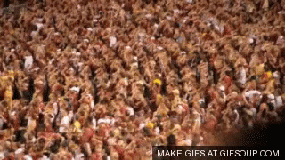 Man Pouring Beer Into Bucket While Group Sits On Lawn GIF