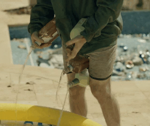 Man Pouring Liquid Into Yellow Pool
