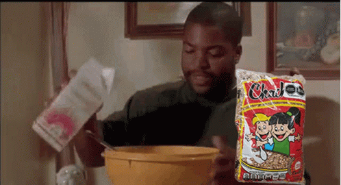 Man Pouring Milk Into Cereal Bowl Holding Bag