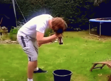 Man Pouring Water Into Black Bucket In Backyard GIF