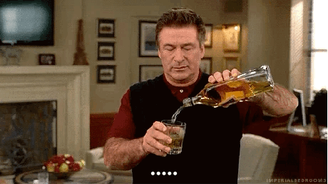Man Pouring Whiskey from Bottle into Glass