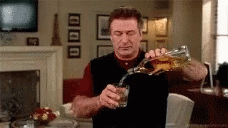 Man Pouring Whiskey From Bottle Into Glass GIF