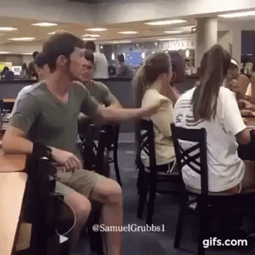 Man Pull Hair Of A Girl Sitting GIF