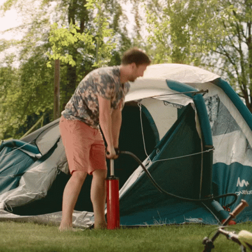 Man Pumping Tent with Red Pump