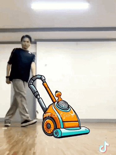 Man Pushing Cartoon Vacuum Cleaner in Dance Studio