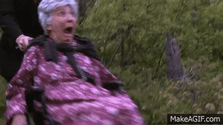Man Pushing Elderly Woman In Pink Dress In Wheelchair GIF