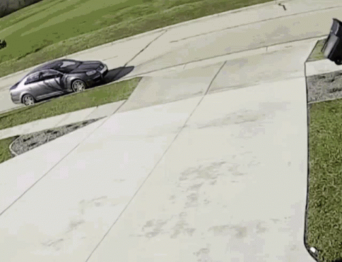 Man Pushing Garbage Can Down Driveway With Car GIF