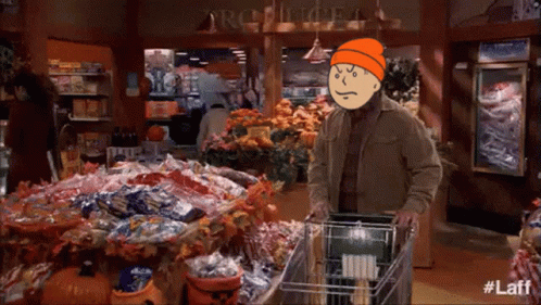 Man Pushing Shopping Cart in Grocery Store With #Laff