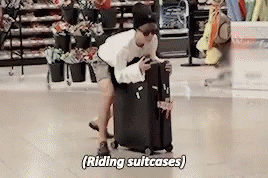 Man Pushing Suitcase Saying Riding Suitcases