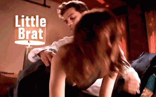 Man Putting Woman on Bed Saying Little Brat