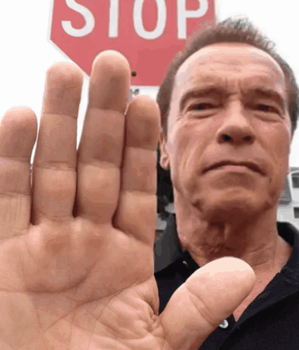 Man Raising Hand At Red Stop Sign GIF