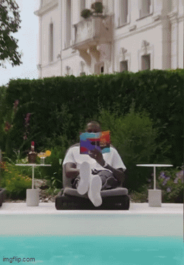 Man Reading Book By Pool Feet In Water GIF