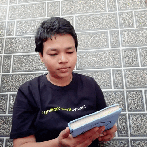Man Reading Book Flips Page GIF